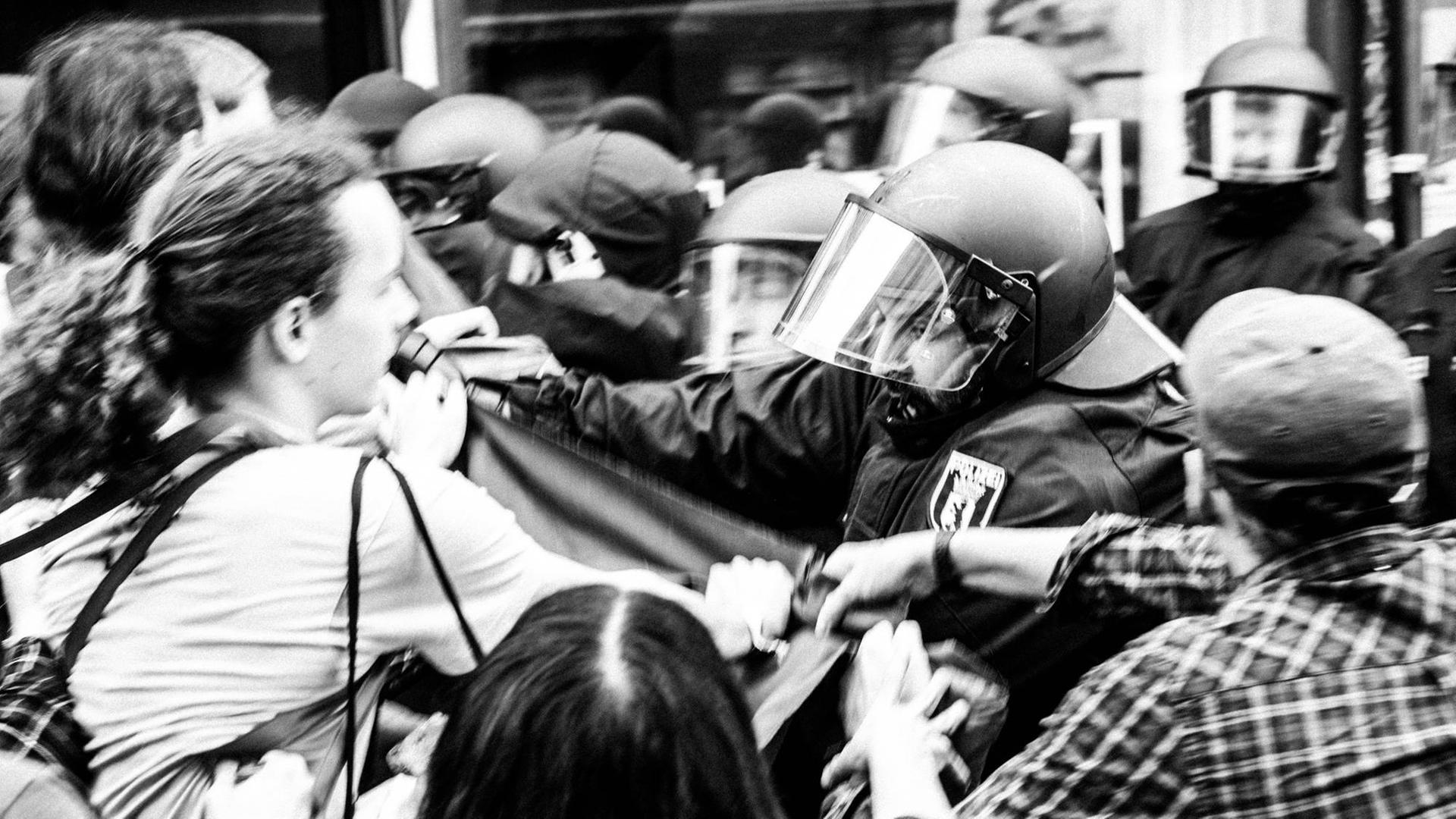 Schwarzweißfoto einer angespannt bis konkret stressigen Situation zwischen Polizei und Hausbesetzern. Schwarzweißfoto einer angespannt bis konkret stressigen Situation zwischen Polizei und Hausbesetzern.