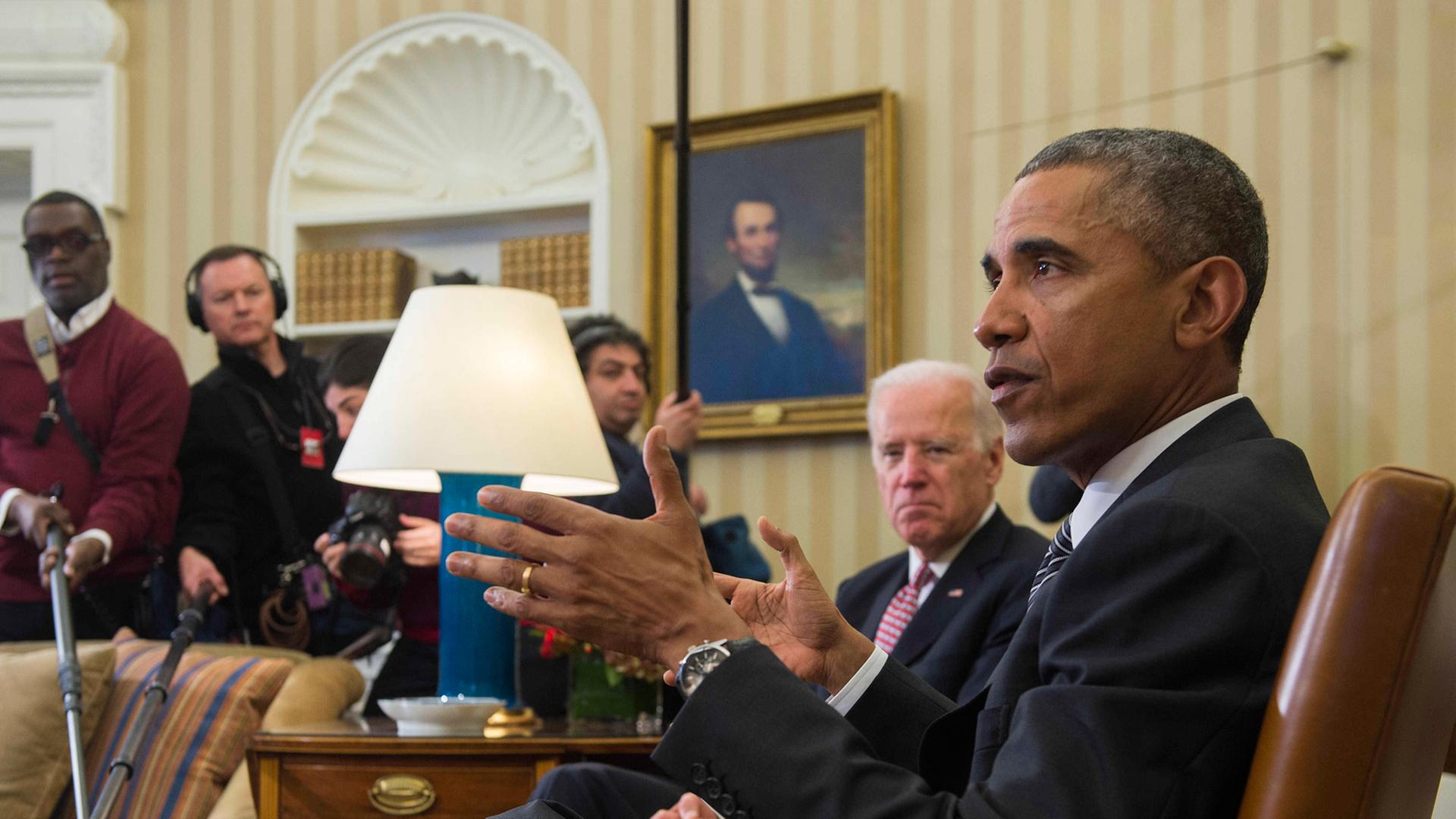US-Präsident Barack Obama und sein Vize Joe Biden sitzen vor Presse im Oval Office, Obama im Vordergrund, von der Seite aufgenommen. US-Präsident Barack Obama und sein Vize Joe Biden sitzen vor Presse im Oval Office, Obama im Vordergrund, von der Seite aufgenommen.