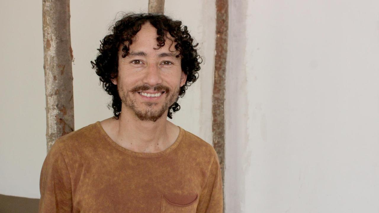 Ricardo Castro steht vor einer Wand und lächelt in die Kamera. Ricardo Castro steht vor einer Wand und lächelt in die Kamera.