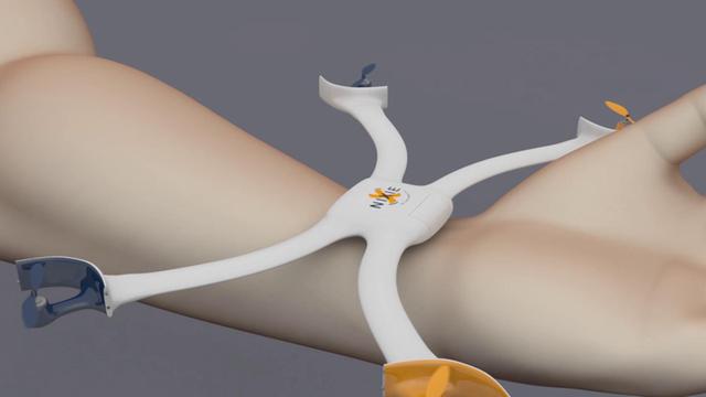 Eine kleine Drohne an einem Handgelenk faltet ihre vier "Flügel" aus.