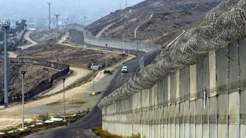 US-Grenzfahnder fahren in einem Auto an Mauern und Befestigungen an der Grenze zu Mexiko entlang, bei Otay Mesa, Kalifornien, USA, am 14. Oktober 2010
