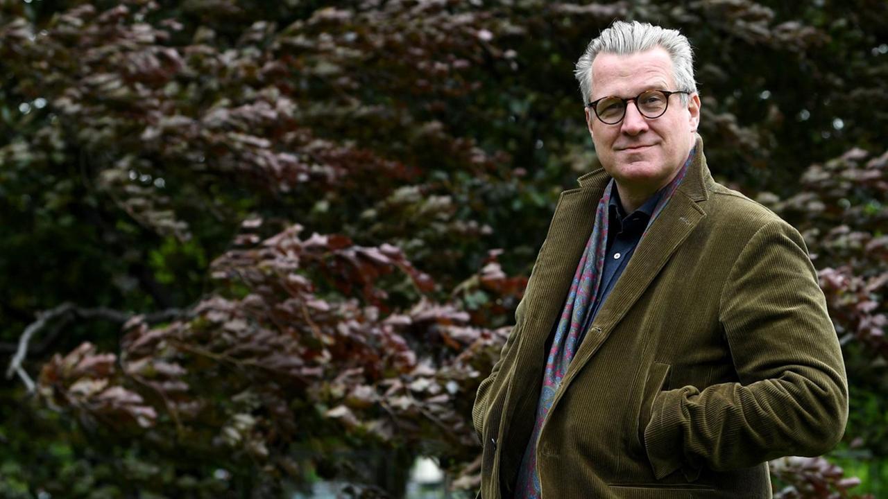 Der Historiker und Schriftsteller Philipp Blom steht vor einer Hecke und schaut in die Kamera. Der Historiker und Schriftsteller Philipp Blom steht vor einer Hecke und schaut in die Kamera.
