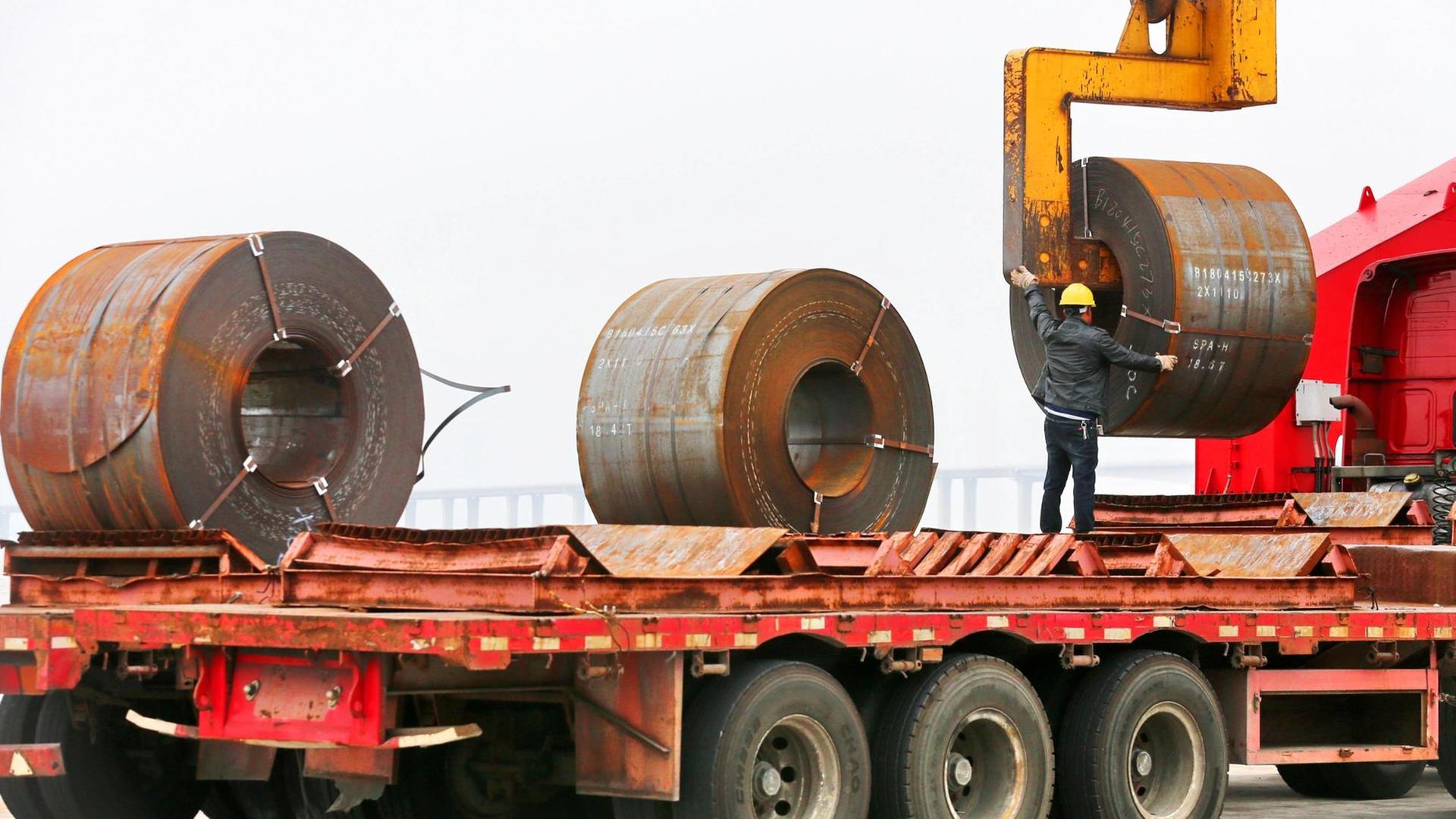 Stahl-Rollen werden auf einen Lkw geladen. Stahl-Rollen werden auf einen Lkw geladen.