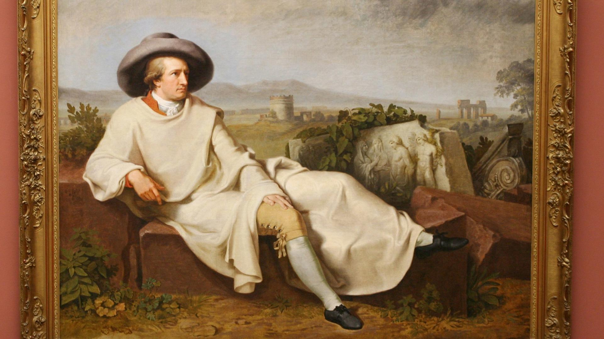 Auf dem Bild "Goethe in der römischen Campagna" von Johann Heinrich Wilhelm Tischbein liegt Goethe hingebettet vor einer italienischen Landschaft Auf dem Bild "Goethe in der römischen Campagna" von Johann Heinrich Wilhelm Tischbein liegt Goethe hingebettet vor einer italienischen Landschaft