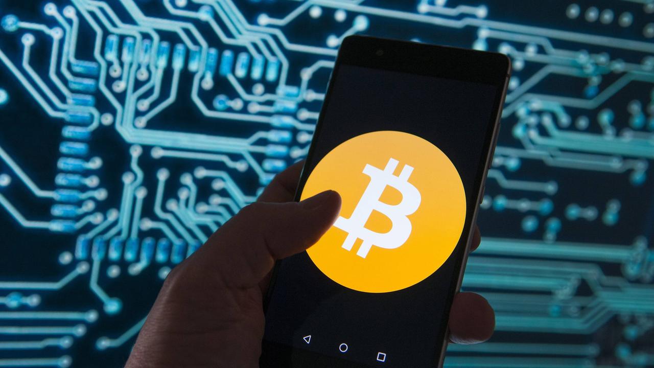 Auf einem Handy ist das Bitcoin-Logo zu sehen. Auf einem Handy ist das Bitcoin-Logo zu sehen.