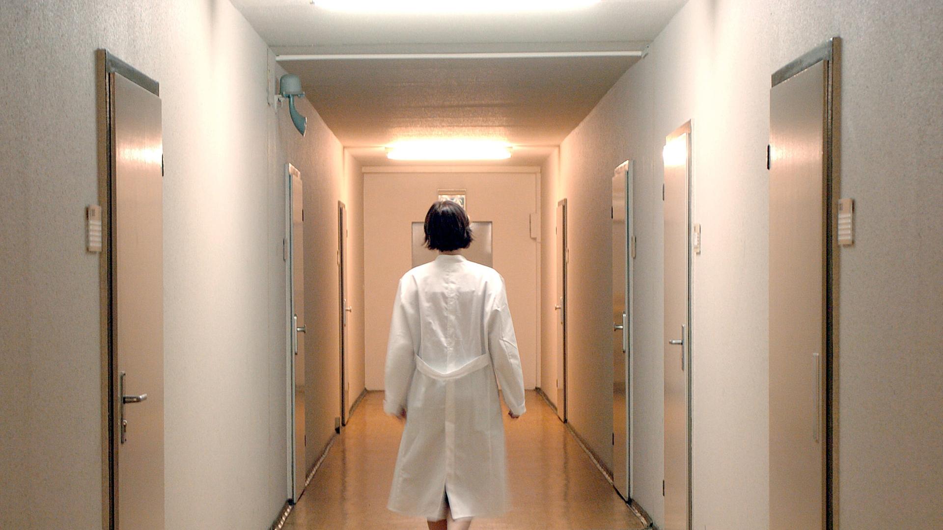 Eine Ärztin läuf allein einen Flur einer Krankenstation in einem Berliner Krankenhaus entlang. Eine Ärztin läuf allein einen Flur einer Krankenstation in einem Berliner Krankenhaus entlang.