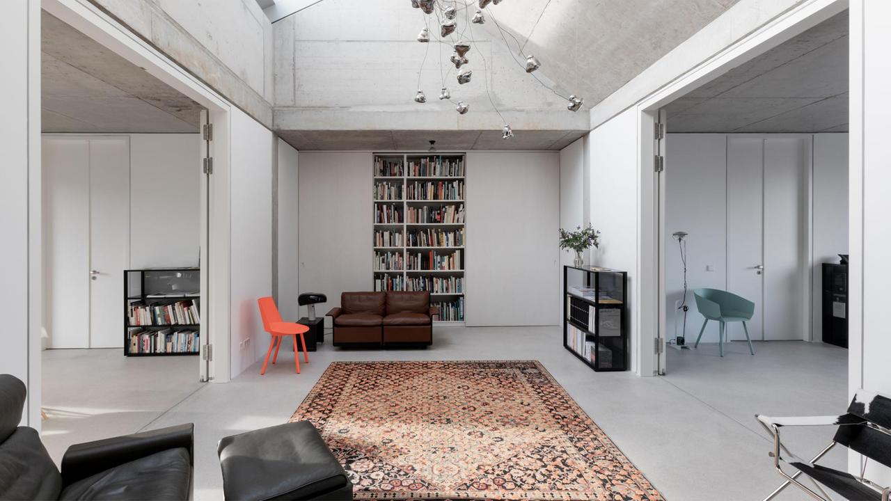 Ein von Oberlicht erleuchtetes, aufgeräumtes Interieur im modern-minimalistischen Stil. Ein von Oberlicht erleuchtetes, aufgeräumtes Interieur im modern-minimalistischen Stil.
