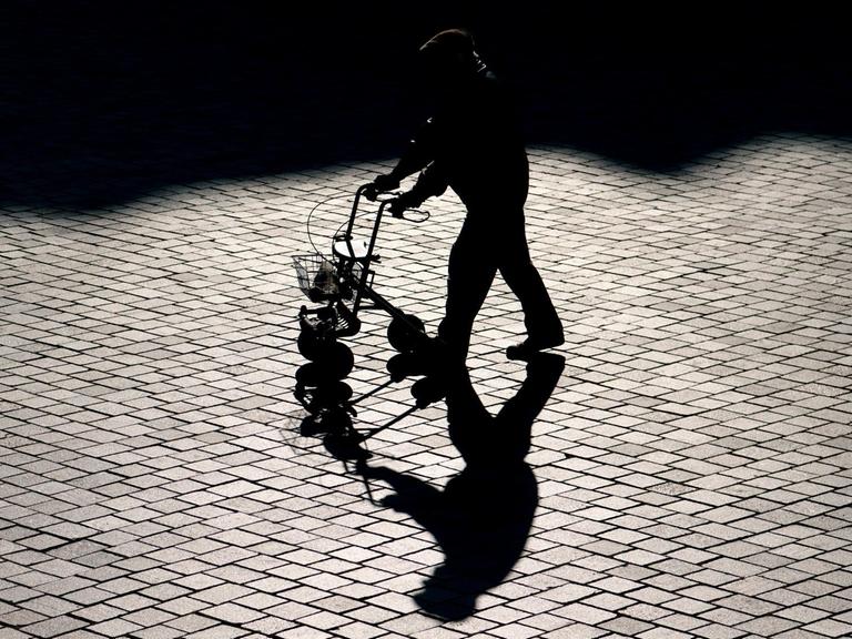 Ein Rentner ist mit einem Rollator in Potsdam unterwegs.