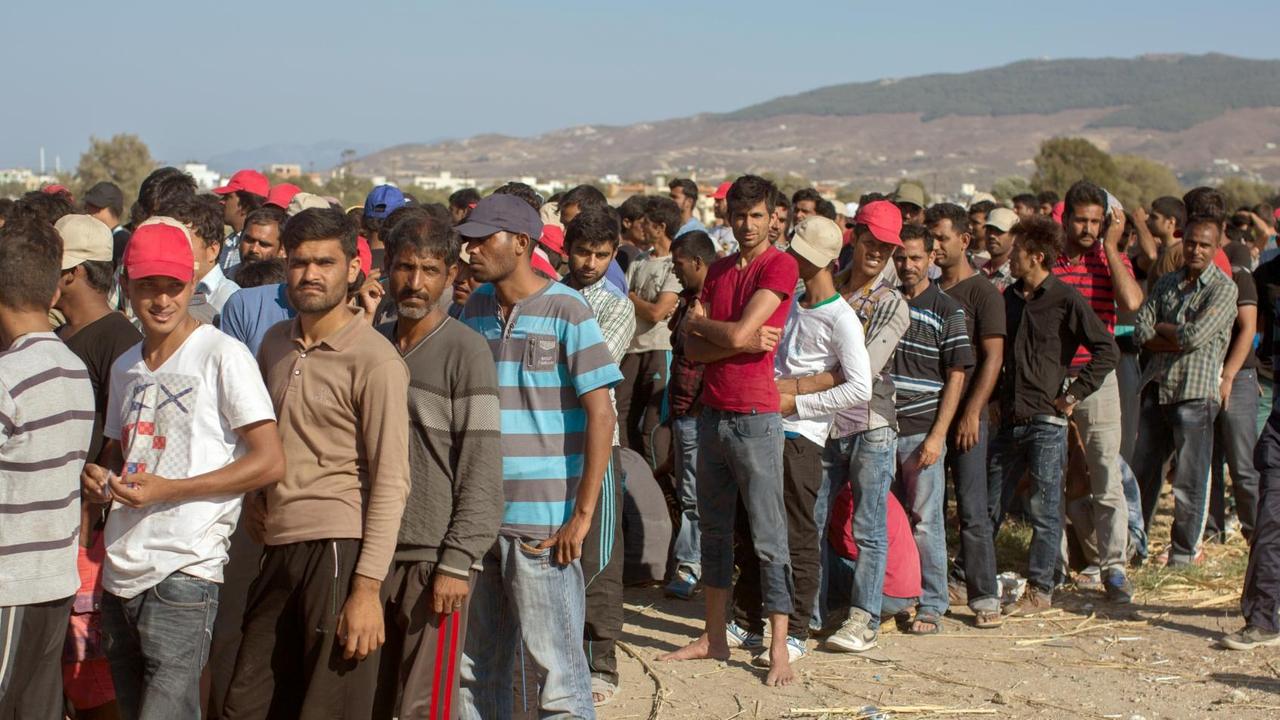 Zu sehen ist eine lange Schlange von Männern auf der Insel Kos in Griechenland. Zu sehen ist eine lange Schlange von Männern auf der Insel Kos in Griechenland.
