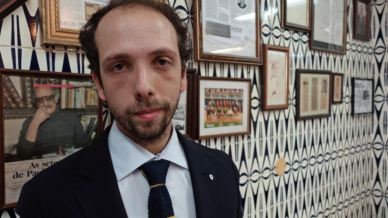Der konservative Kolumnist João Esteves Lemos vor einer Wand imt Politikerfotos in einem Restaurant in Lissabon Der konservative Kolumnist João Esteves Lemos vor einer Wand imt Politikerfotos in einem Restaurant in Lissabon