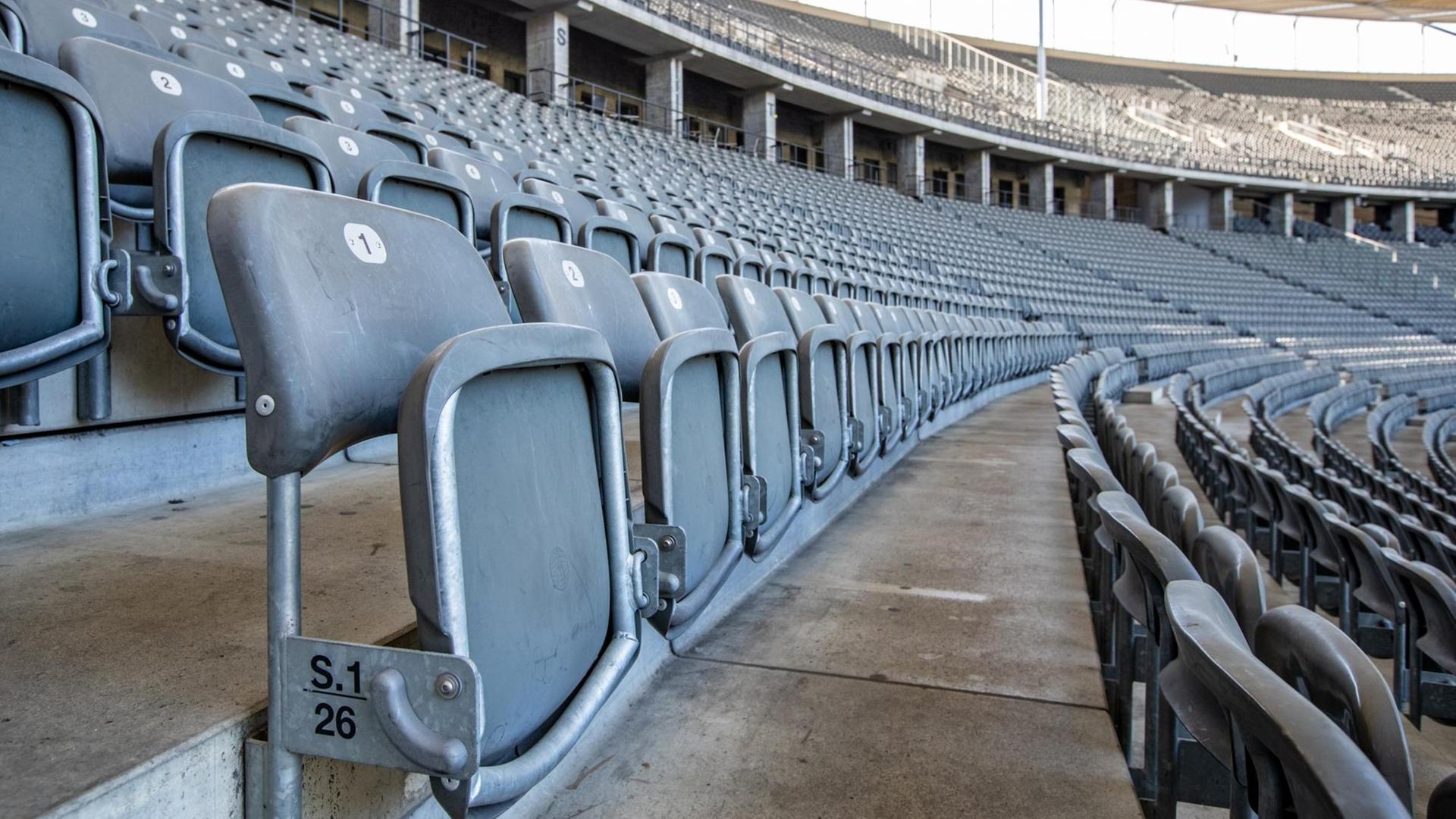 Die Sitze in den Reihen des menschenleeren Olympiastadions sind hochgeklappt.