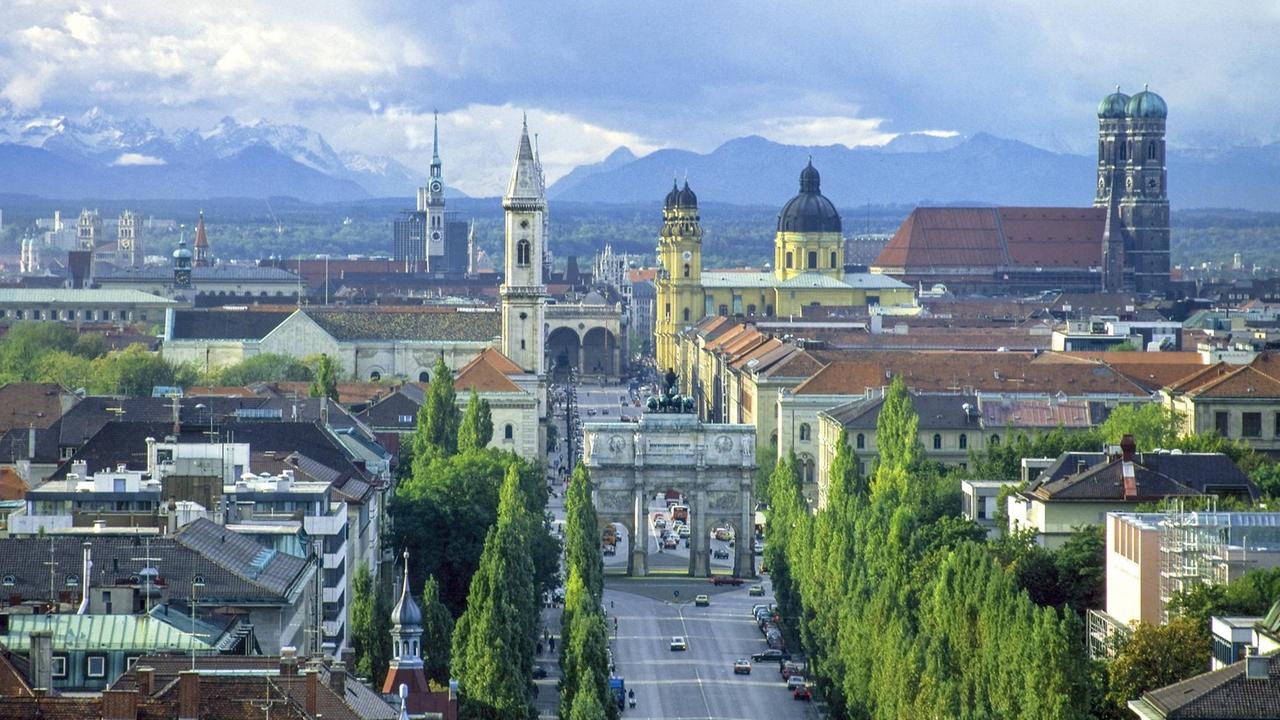 Münchner Stadtlandschaft mit der schnurstracks geraden Ludwigstraße und dem Siegestor. Rechts hinten ist die Frauenkirche zu sehen. Münchner Stadtlandschaft mit der schnurstracks geraden Ludwigstraße und dem Siegestor. Rechts hinten ist die Frauenkirche zu sehen.