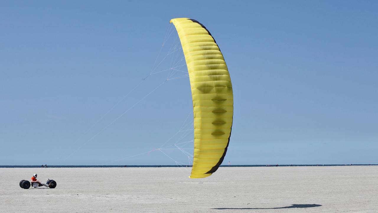 Ein Kitebuggy-Fahrer am Strand von St. Peter-Ording. Ein Kitebuggy-Fahrer am Strand von St. Peter-Ording.