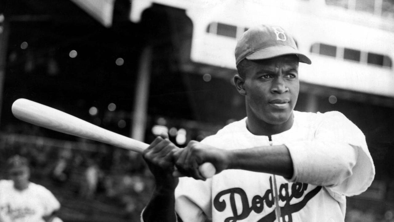 Porträt von Jackie Robinson mit einem Baseball-Schläger in der Hand. Porträt von Jackie Robinson mit einem Baseball-Schläger in der Hand.