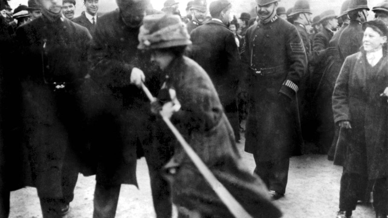 Eine Frauenrechtlerin wird von der Polizei abgeführt Eine Frauenrechtlerin wird von der Polizei abgeführt