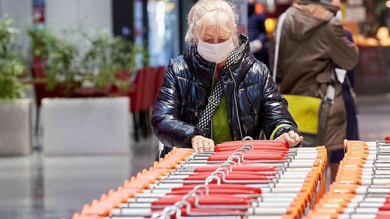 Eine Frau mit einer Stoffmaske in einem Supermarkt in Wien Eine Frau mit einer Stoffmaske in einem Supermarkt in Wien