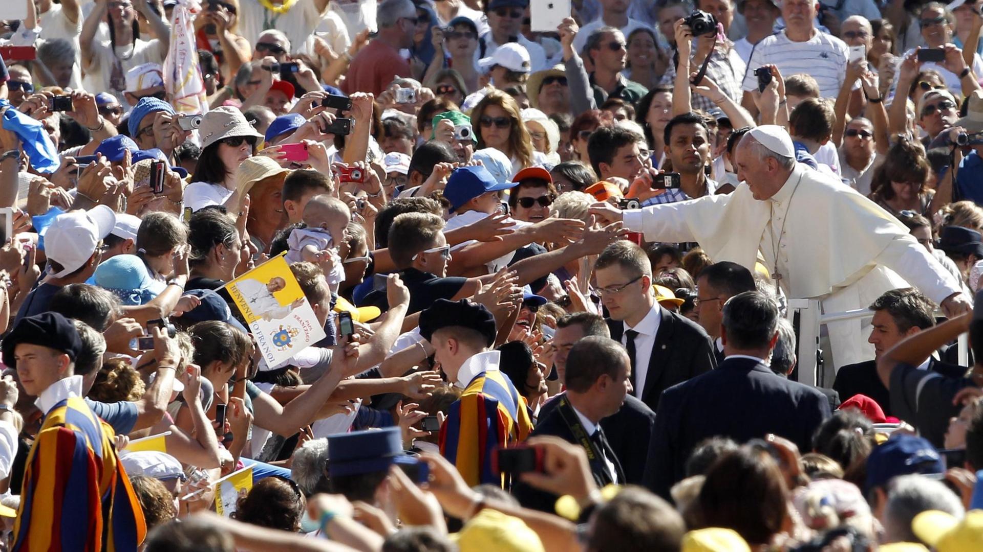 Papst Franziskus fährt während einer Generalaudienz durch die Menschenmenge. Papst Franziskus fährt während einer Generalaudienz durch die Menschenmenge.