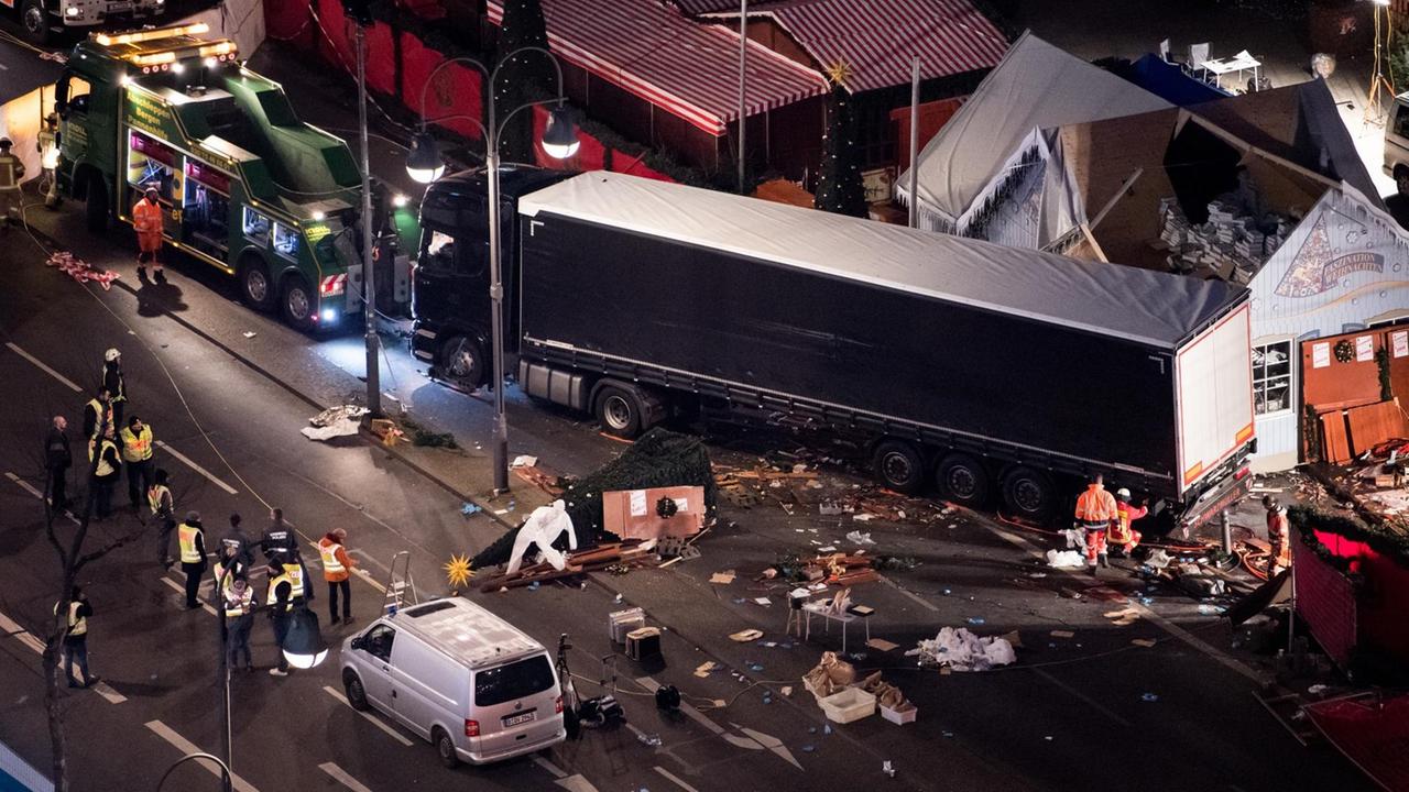 Sie sehen den Sattelschlepper, mit dem der Anschlag verübt wurde, Arbeiter befestigen ihn am 20.12.2016 auf dem Weihnachtsmarkt am Breitscheidplatz in Berlin an einem Abschleppwagen. Sie sehen den Sattelschlepper, mit dem der Anschlag verübt wurde, Arbeiter befestigen ihn am 20.12.2016 auf dem Weihnachtsmarkt am Breitscheidplatz in Berlin an einem Abschleppwagen.