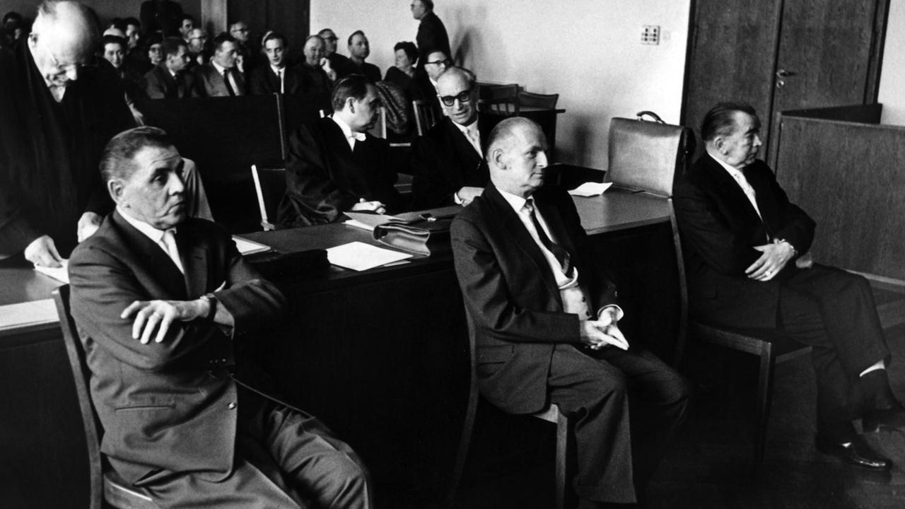 Die drei Angeklagten (l-r) Theodor Pillich, Hans Hoffmann und Kurt Kirschner sitzen am 22.03.1962 vor dem Schwurgericht in Gießen. Ihnen wurde im sogenannten Judenmordprozeß vorgeworfen, an der Ermordung hunderter Juden in der polnischen Kreisstadt Ostrow Mazewieck beteiligt gewesen zu sein.