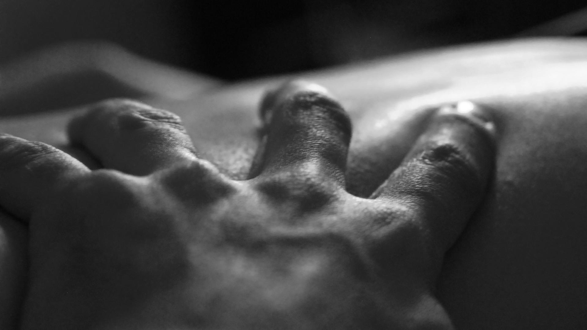 Eine Hand greift in die Haut eines anderen Menschen. Eine Hand greift in die Haut eines anderen Menschen.