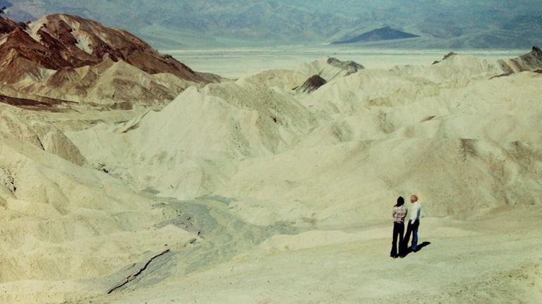 In der Landschaft von Death Valley stehen zwei kleine Menschen - Foucault und Stoneman.