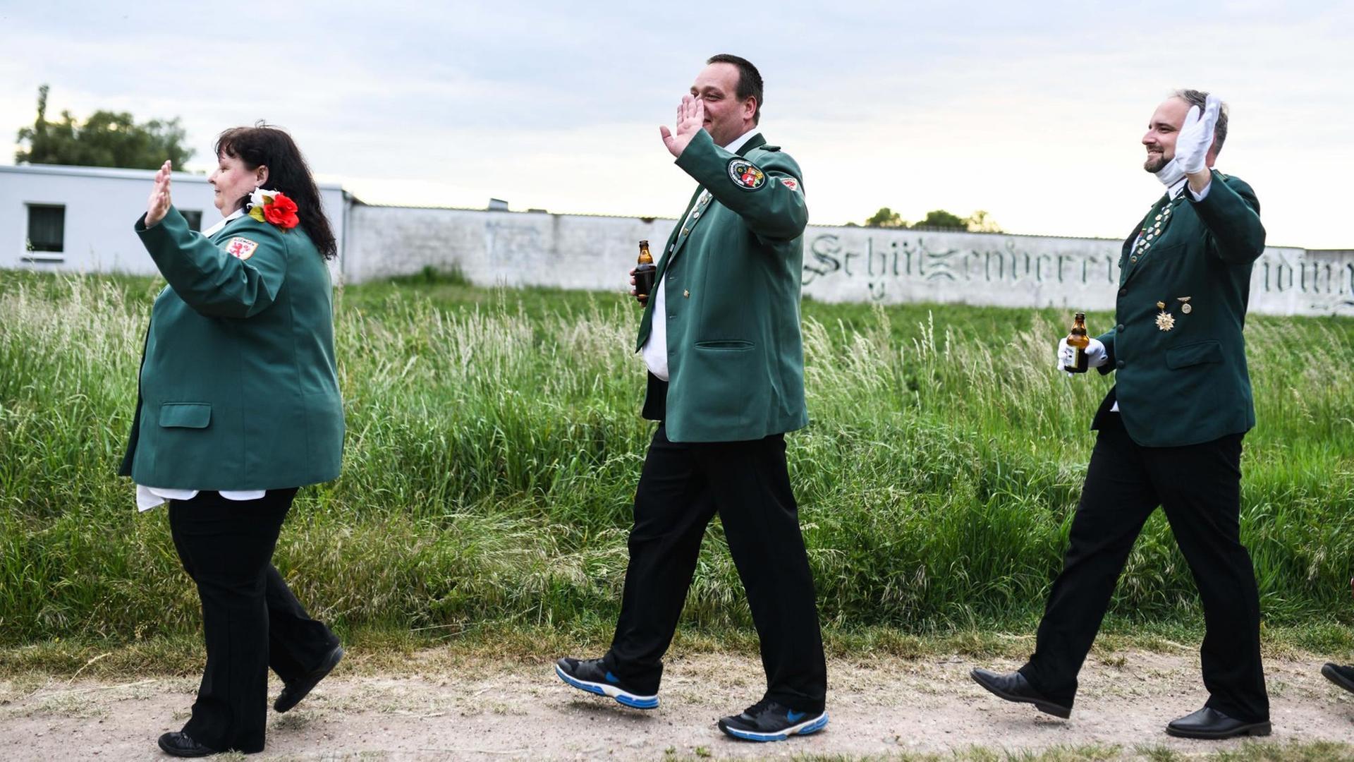 Eine Frau und zwei Männer in grünen Uniformen paradieren vor einer Wiese. Der Schuetzenverein Gleidingen veranstaltet mit dem Freien Fanfarenkorps Alt-Laatzen einen Livestream als Ersatz für das abgesagte Schuetzenfest am Pfingstwochenende. Eine Frau und zwei Männer in grünen Uniformen paradieren vor einer Wiese. Der Schuetzenverein Gleidingen veranstaltet mit dem Freien Fanfarenkorps Alt-Laatzen einen Livestream als Ersatz für das abgesagte Schuetzenfest am Pfingstwochenende.