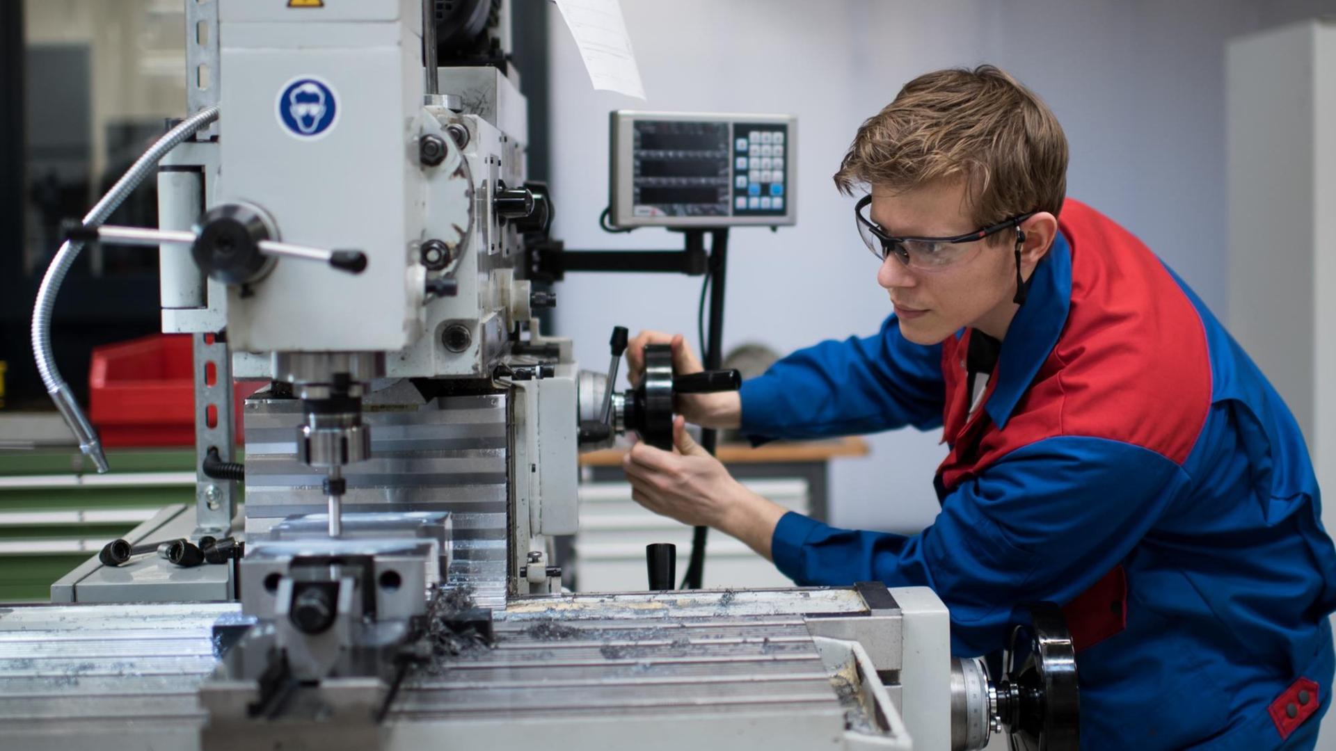 Ein Auszubildender arbeitet in einer Ausbildungswerkstatt für Mechaniker Ein Auszubildender arbeitet in einer Ausbildungswerkstatt für Mechaniker