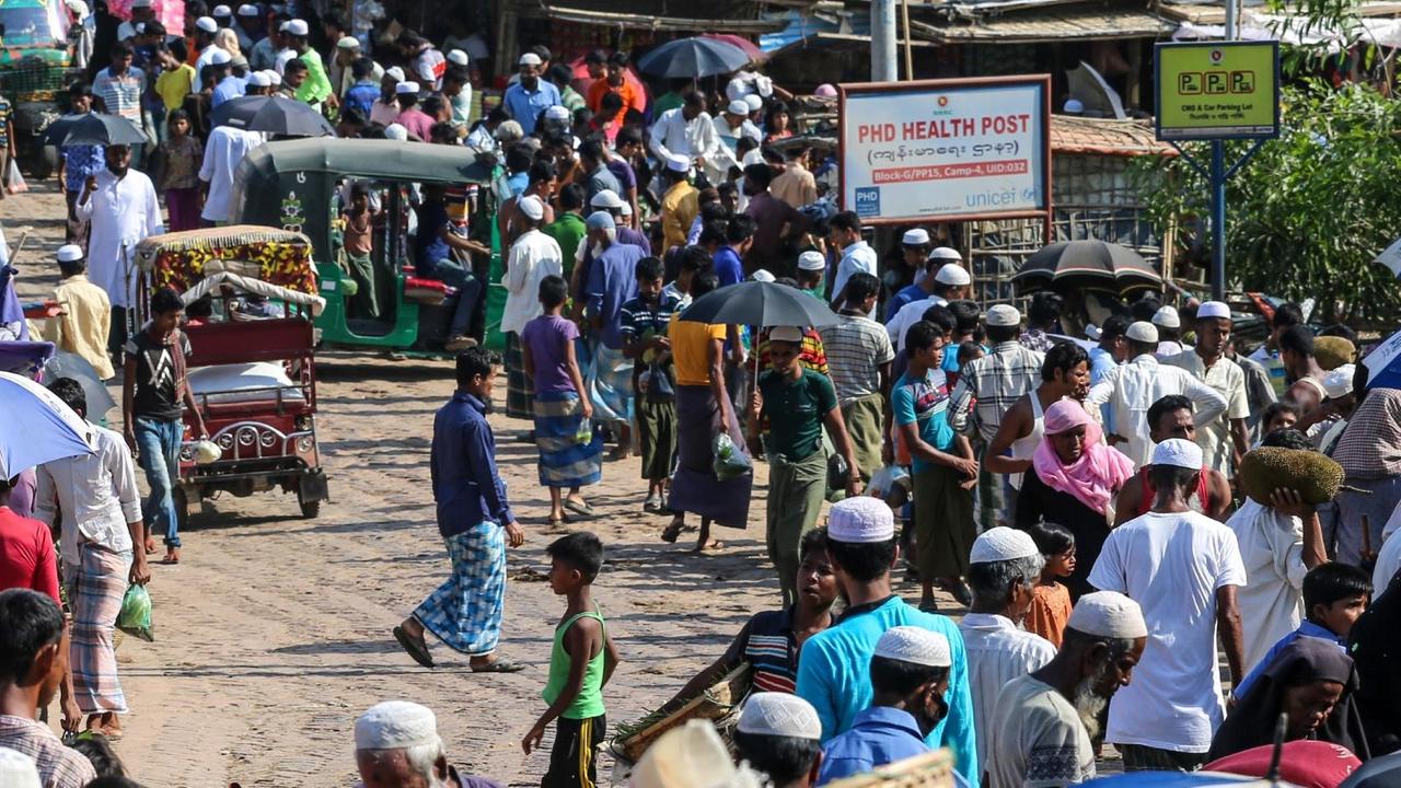 In this file photo taken on May 15, 2020 Rohingya refugees gather at a market as first cases of COVID-19 coronavirus have emerged in the area, in Kutupalong refugee camp in Ukhia. Four more Rohingya refugees at vast camps in Bangladesh have tested positive for coronavirus, taking the total to 25, health officials said on May 25, 10 days after the first cases were confirmed.