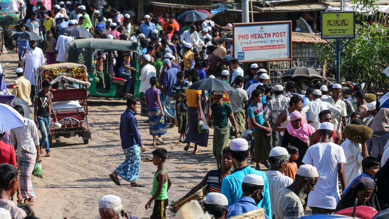 In this file photo taken on May 15, 2020 Rohingya refugees gather at a market as first cases of COVID-19 coronavirus have emerged in the area, in Kutupalong refugee camp in Ukhia. Four more Rohingya refugees at vast camps in Bangladesh have tested positive for coronavirus, taking the total to 25, health officials said on May 25, 10 days after the first cases were confirmed. In this file photo taken on May 15, 2020 Rohingya refugees gather at a market as first cases of COVID-19 coronavirus have emerged in the area, in Kutupalong refugee camp in Ukhia. Four more Rohingya refugees at vast camps in Bangladesh have tested positive for coronavirus, taking the total to 25, health officials said on May 25, 10 days after the first cases were confirmed.