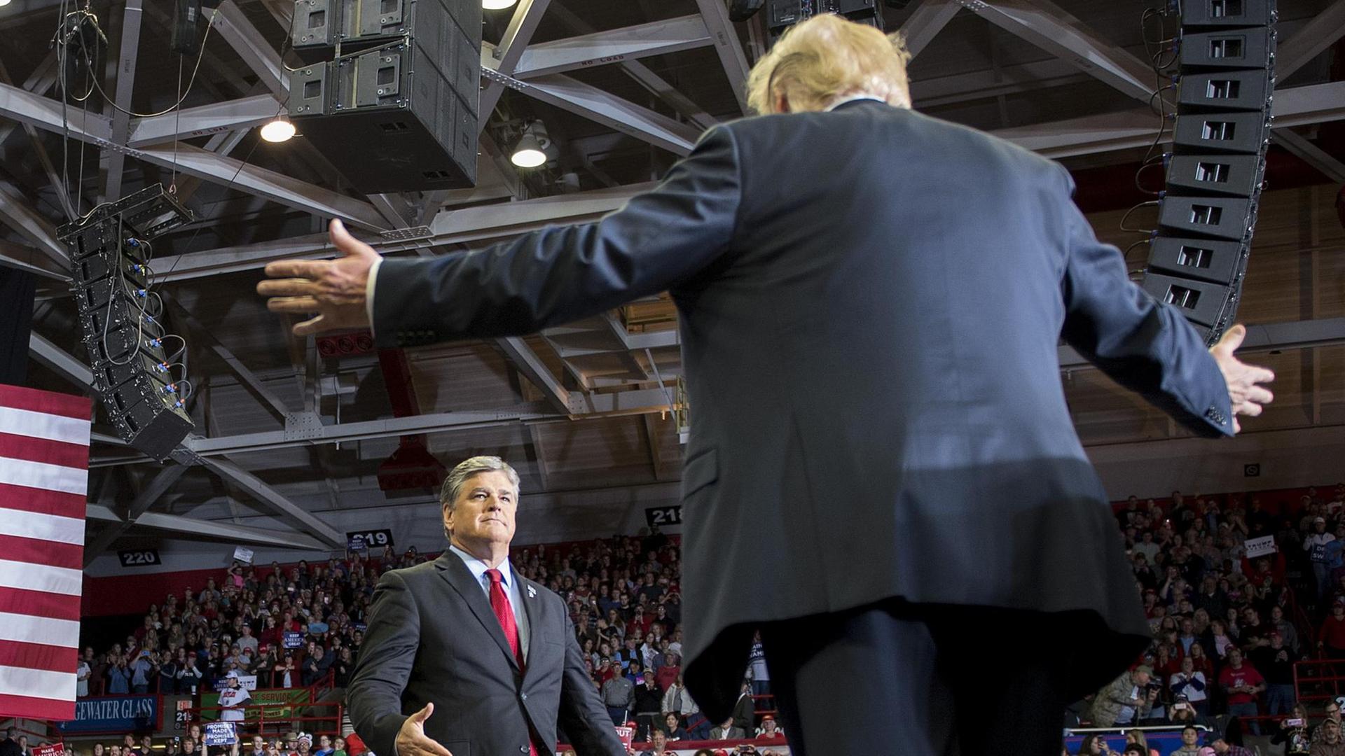 US President Donald Trump greets talk show host Sean Hannity at a Make America Great Again rally in Cape Girardeau, Missouri on November 5, 2018. (Photo by Jim WATSON / AFP) US President Donald Trump greets talk show host Sean Hannity at a Make America Great Again rally in Cape Girardeau, Missouri on November 5, 2018. (Photo by Jim WATSON / AFP)