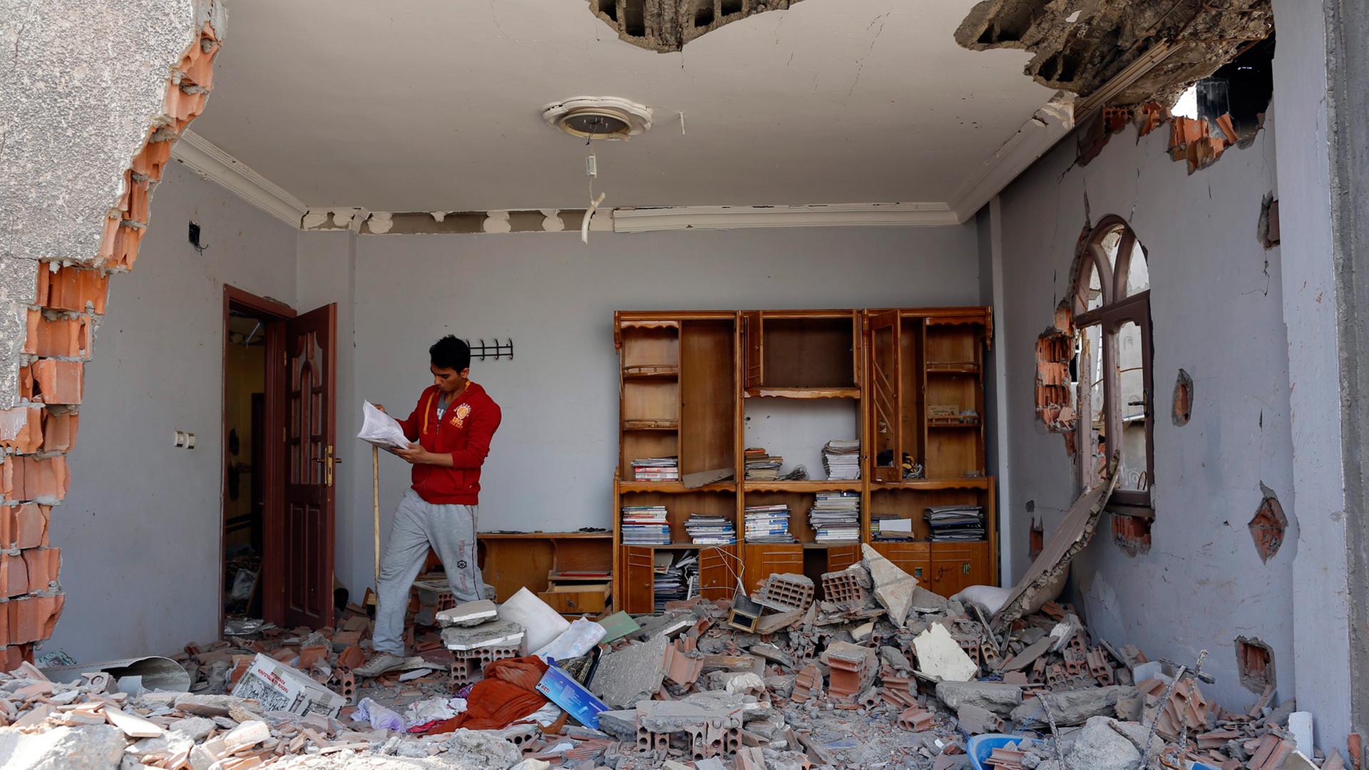 Ein kurdischer Mann schaut sich in seinem zerstörten Haus in der anatolischen Stadt Cizre um. Hier kämpfen türkische Regierungstruppen gegen PKK-Einheiten; Aufnahme vom 3. März 2016 Ein kurdischer Mann schaut sich in seinem zerstörten Haus in der anatolischen Stadt Cizre um. Hier kämpfen türkische Regierungstruppen gegen PKK-Einheiten; Aufnahme vom 3. März 2016