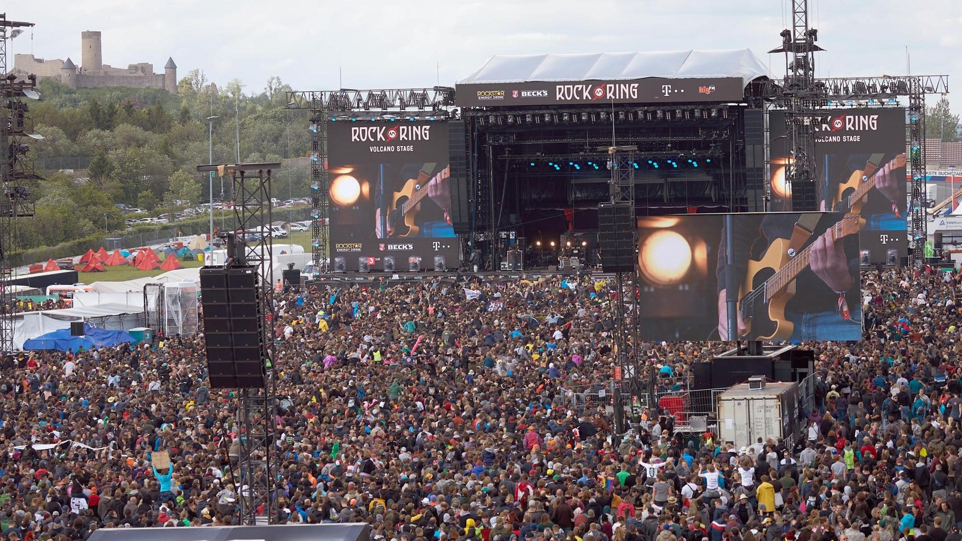 Musik-Fans während eines Konzerts vor der Bühne von dem Festival "Rock am Ring" im Jahr 2019. Musik-Fans während eines Konzerts vor der Bühne von dem Festival "Rock am Ring" im Jahr 2019.