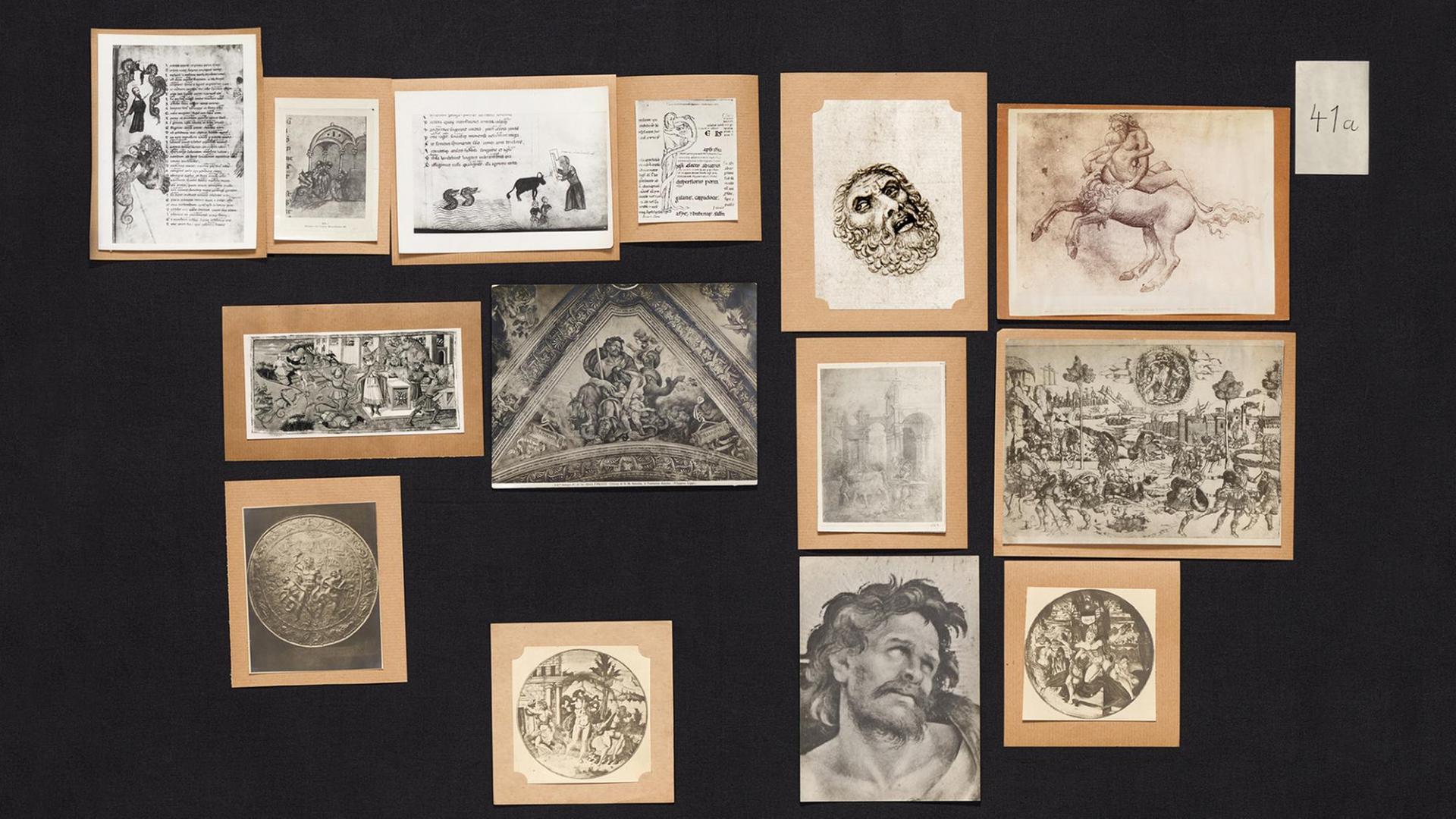 Aby Warburgs "Bilderatlas Mnemosyne", Teilansicht von Panel 41a (wiederhergestellt/recovered). Die einzelnen Bildmotive liegen geordnet auf schwarzen Grund. Aby Warburgs "Bilderatlas Mnemosyne", Teilansicht von Panel 41a (wiederhergestellt/recovered). Die einzelnen Bildmotive liegen geordnet auf schwarzen Grund.