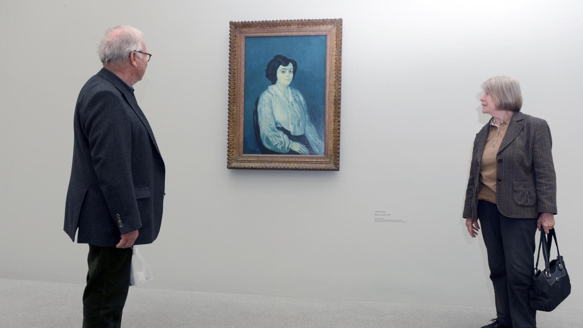 Zwei Besucher betrachten am Donnerstag (29.03.2012) in der Ausstellung «Frauen» in der Pinakothek der Moderne in München das Gemälde «Madame Soler» (1903) von Pablo Picasso. Anlässlich des zehnjährigen Bestehens zeigt die Pinakothek der Moderne die Weiblichkeit aus der Sicht von drei Malern des 20. Jahrhunderts. Die Schau wird am 29.03.2012 eröffnet und ist bis 15.07.2012 zu sehen. Foto: Felix Hörhager dpa/lby | Verwendung weltweit Zwei Besucher betrachten am Donnerstag (29.03.2012) in der Ausstellung «Frauen» in der Pinakothek der Moderne in München das Gemälde «Madame Soler» (1903) von Pablo Picasso. Anlässlich des zehnjährigen Bestehens zeigt die Pinakothek der Moderne die Weiblichkeit aus der Sicht von drei Malern des 20. Jahrhunderts. Die Schau wird am 29.03.2012 eröffnet und ist bis 15.07.2012 zu sehen. Foto: Felix Hörhager dpa/lby | Verwendung weltweit