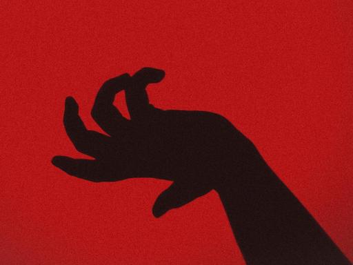 Die Silhouette einer Hand vor einem roten Hintergrund