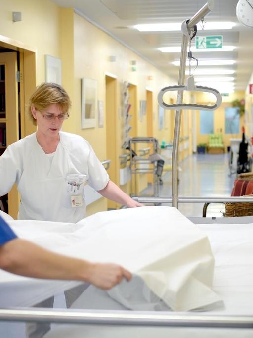 Pflegerinnen bereiten ein Bett in der Palliativstation der Charité in Berlin vor