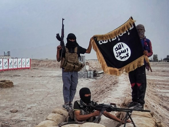 Isis-Kämpfer mit Maschinengewehren posieren mit der schwarzen Flagge der Gruppe für ein Foto