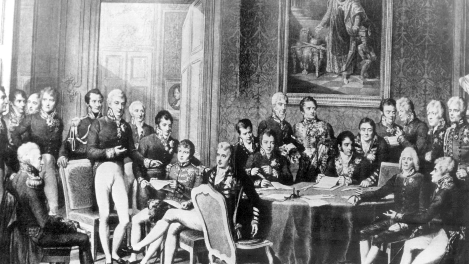 Der Wiener Kongreß (18. September 1814 bis 9. Juni 1815) unter Vorsitz von Klemens Wenzel Fürst von Metternich (stehend 6.v.l.) Der österreichische Staatsmann versuchte durch Kongreßdiplomatie, die vorrevolutionäre politische und soziale Ordnung in Europa wiederherzustellen.