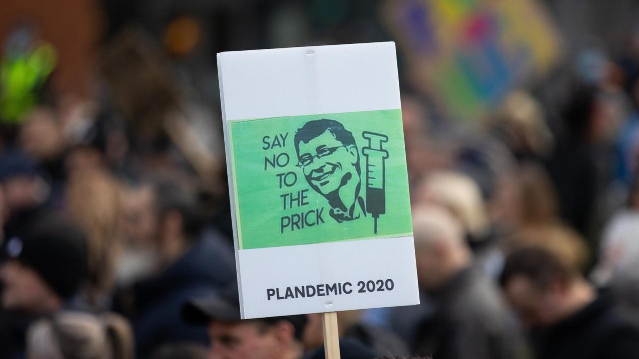 Bei einer Demonstration in England wird ein grünes Schild hochgehalten, auf dem der Kopf von Bill Gates und eine Spritze abgebildet sind. Bei einer Demonstration in England wird ein grünes Schild hochgehalten, auf dem der Kopf von Bill Gates und eine Spritze abgebildet sind.
