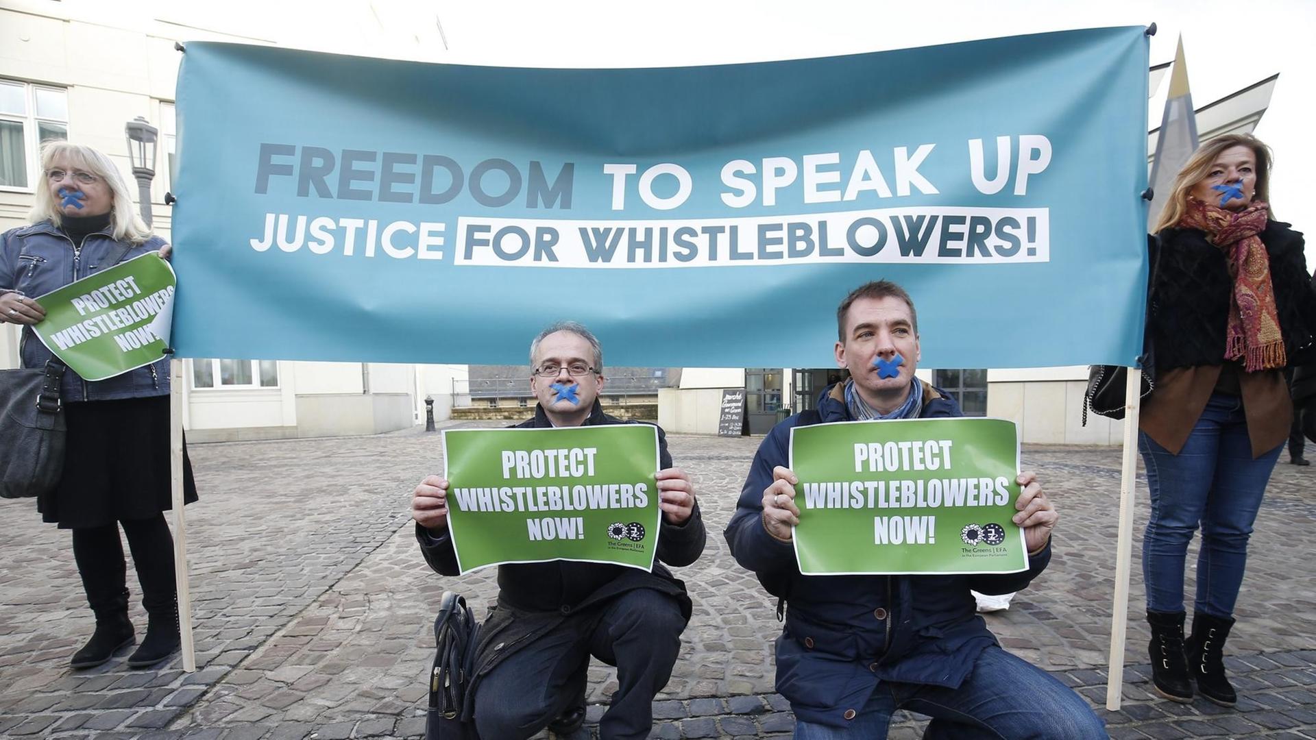 People hold placards 'Freedom to Speak Up, Justice for Whistleblowers!' and 'Protect Whistleblowers Now' during a demonstration at the start of the so-called LuxLeaks Whistleblower appeal trial, in the criminal court in Luxembourg, 12 December 2016. Three men, two former employees of accounting firm PricewaterhouseCoopers (PwC) Antoine Deltour and Raphael Halet and a journalist Edouard Perrin were on trial for leaking thousands of confidential documents revealing corporate tax deals. The court on 29 June 2016 handed suspended sentences to Antoine Deltour and Raphael Halet, while journalist Edouard Perrin was acquitted of all charges. People hold placards 'Freedom to Speak Up, Justice for Whistleblowers!' and 'Protect Whistleblowers Now' during a demonstration at the start of the so-called LuxLeaks Whistleblower appeal trial, in the criminal court in Luxembourg, 12 December 2016. Three men, two former employees of accounting firm PricewaterhouseCoopers (PwC) Antoine Deltour and Raphael Halet and a journalist Edouard Perrin were on trial for leaking thousands of confidential documents revealing corporate tax deals. The court on 29 June 2016 handed suspended sentences to Antoine Deltour and Raphael Halet, while journalist Edouard Perrin was acquitted of all charges.
