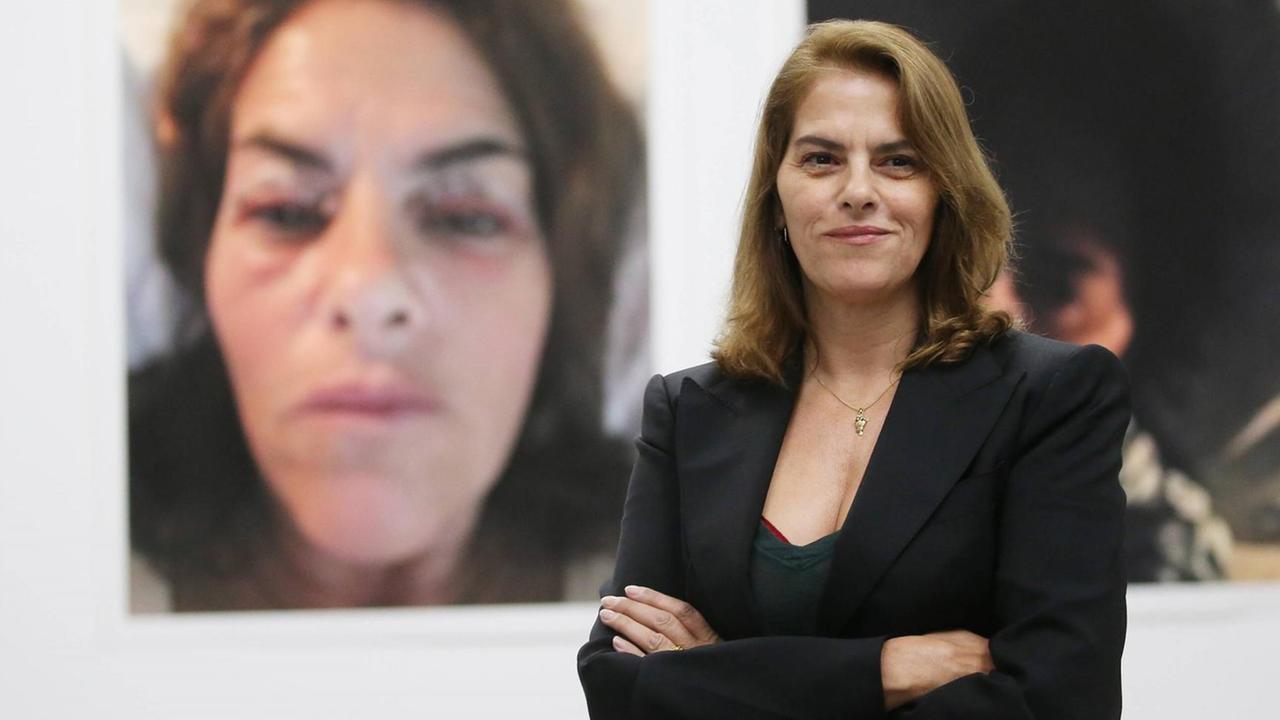 Tracey Emin steht vor einem ihrer Fotos und lächelt. Tracey Emin steht vor einem ihrer Fotos und lächelt.