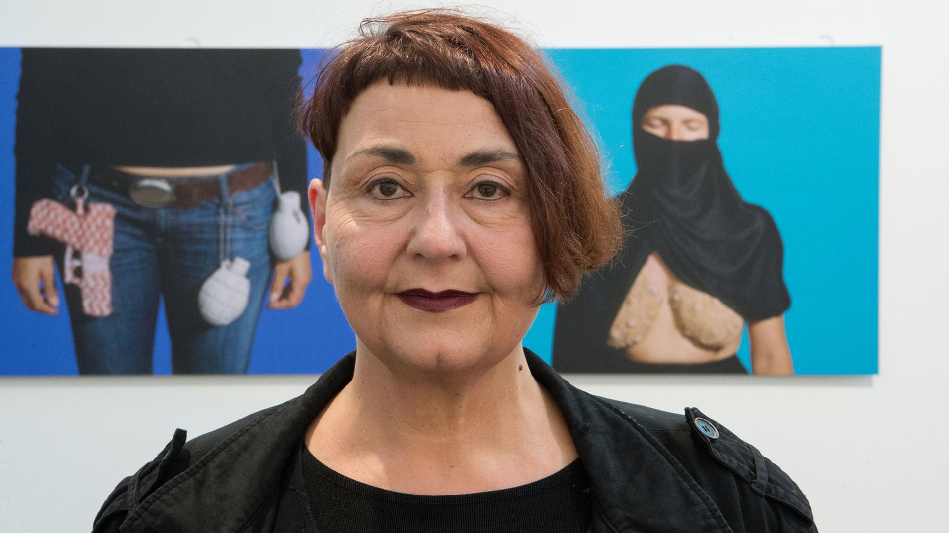 Die Künstlerin Adidal Abou-Chamat steht am 26.02.2016 im Kunstverein in Ludwigsburg (Baden-Württemberg) in der Ausstellung "Inter-Sections" vor zwei Prints ihres 7-teiligen Kunstwerks "In-between" aus dem Jahr 2006 Die Künstlerin Adidal Abou-Chamat steht am 26.02.2016 im Kunstverein in Ludwigsburg (Baden-Württemberg) in der Ausstellung "Inter-Sections" vor zwei Prints ihres 7-teiligen Kunstwerks "In-between" aus dem Jahr 2006