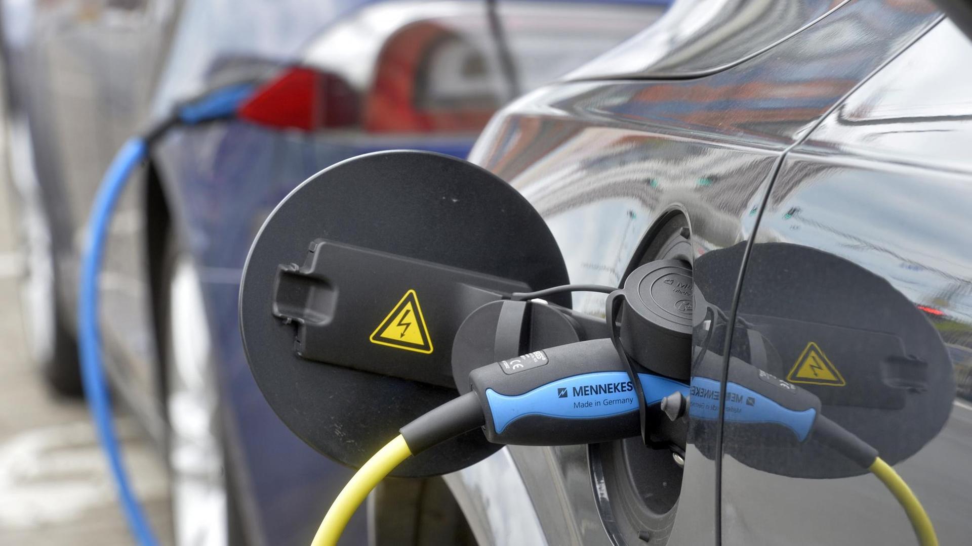 An einer Ladestation im Zentrum von Leipzig am Augustusplatz stehen Elektroautos - ein Tesla und ein Volvo - zum "Auftanken". An einer Ladestation im Zentrum von Leipzig am Augustusplatz stehen Elektroautos - ein Tesla und ein Volvo - zum "Auftanken".