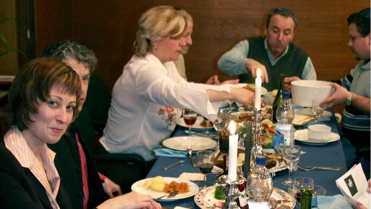Eine jüdische Gemeinde beim Essen der symbolischen Pessach-Speisen während des Sederabends, dem Abend vor dem Pessach-Fest