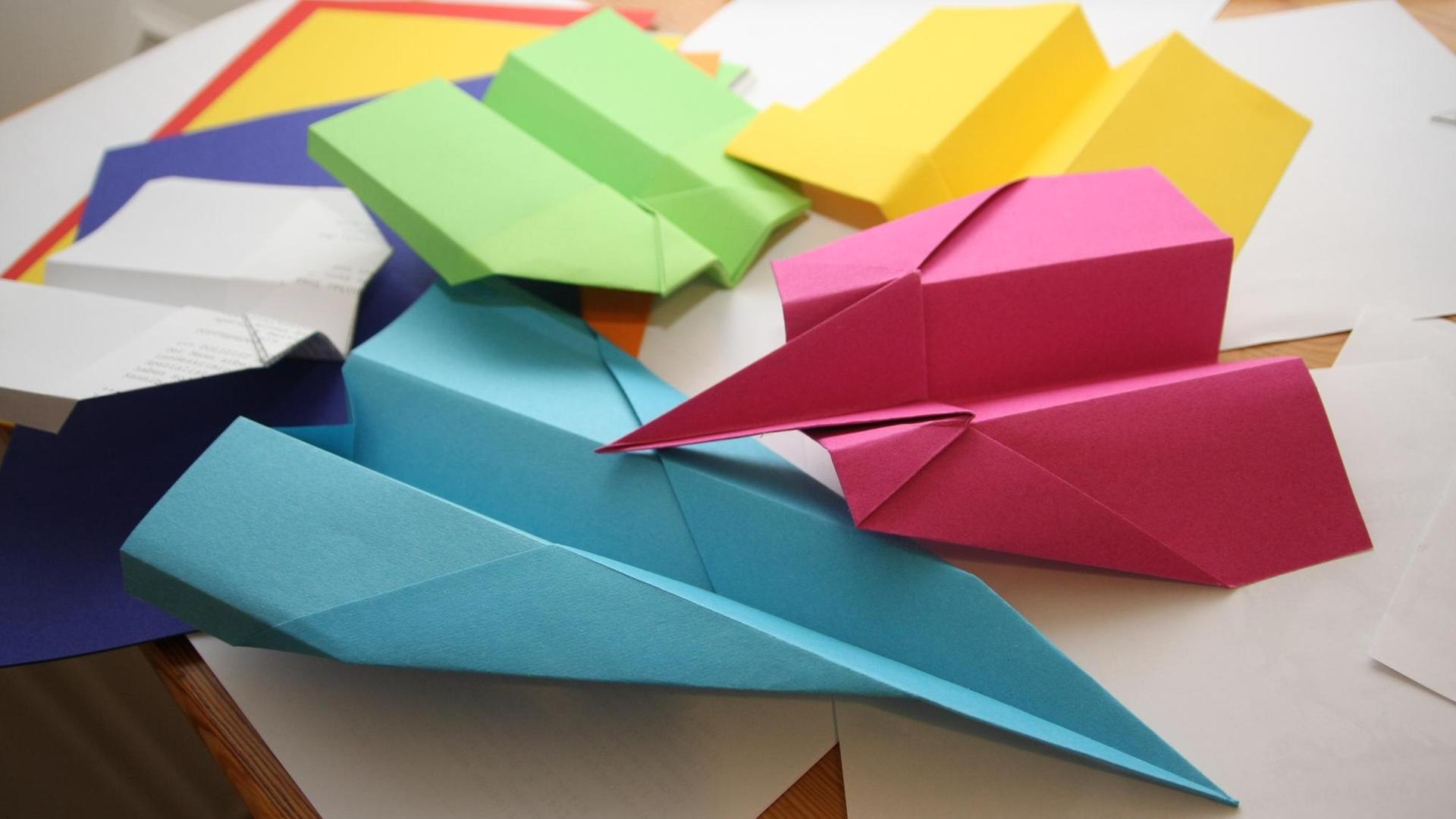 Papierflieger, die grün, gelb und blau sind. Papierflieger, die grün, gelb und blau sind.
