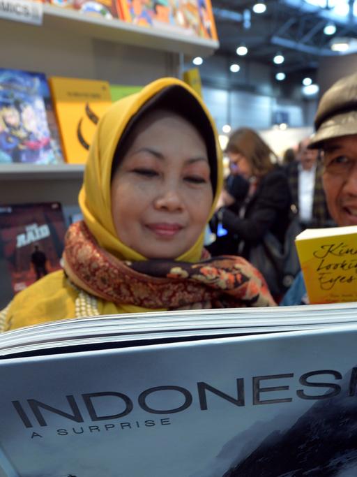Am Stand von Indonesien posieren der indonesische Autor Ahmad Tohari (r) und Sri Kuwati am 12.03.2015 auf der Buchmesse in Leipzig (Sachsen).