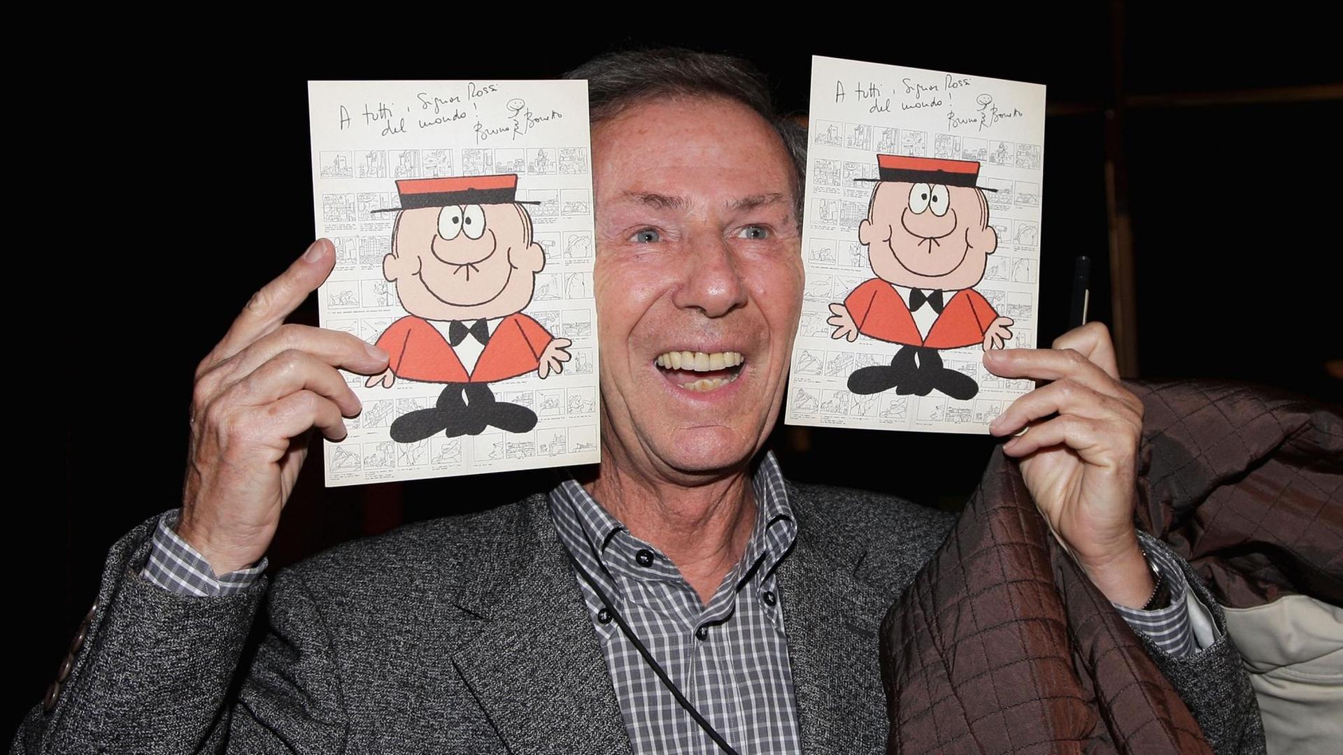 Bruno Bozetto hält zwei Zeichnungen mit seiner bekanntesten Figur Herr Rossi in die Höhe. "Minimalistische Karikaturen", sagt Rolf Giesen zum Stil. Bruno Bozetto hält zwei Zeichnungen mit seiner bekanntesten Figur Herr Rossi in die Höhe. "Minimalistische Karikaturen", sagt Rolf Giesen zum Stil.