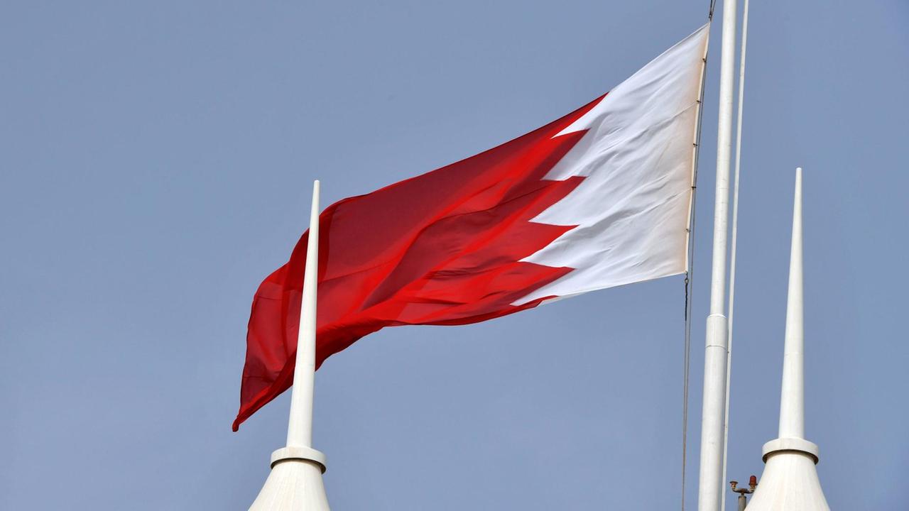 Die Flagge von Bahrain ist rot-weiß mit Zacken zwischen den Farbfelder. Sie weht im Wind. Die Flagge von Bahrain ist rot-weiß mit Zacken zwischen den Farbfelder. Sie weht im Wind.