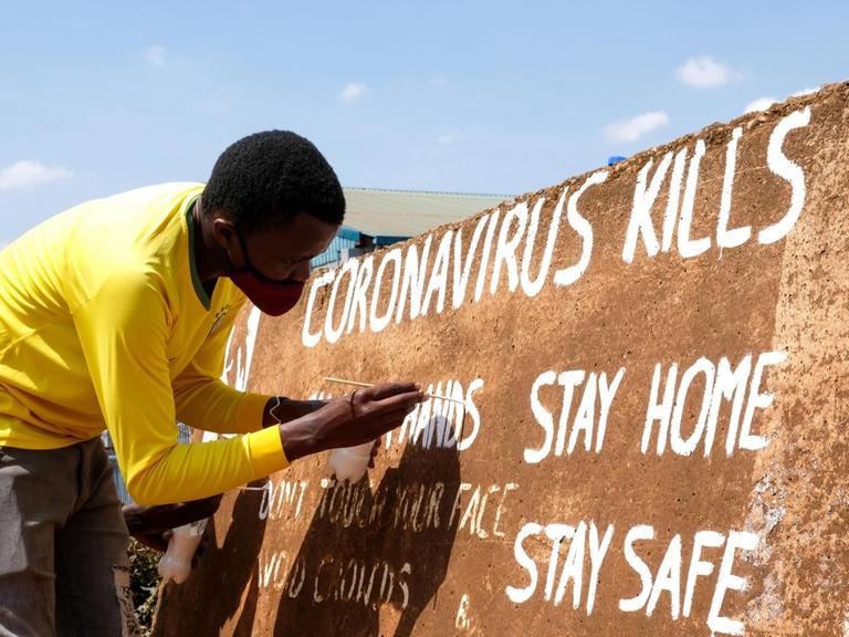 (200929) -- KAMPALA, Sept. 29, 2020 (Xinhua) -- Visual artist Henry Jonathan Waguti works on a roadside wall as part of an anti-coronavirus awareness campaign in Kampala, capital of Uganda, Sept. 29, 2020. (Photo by Hajarah Nalwadda/Xinhua)