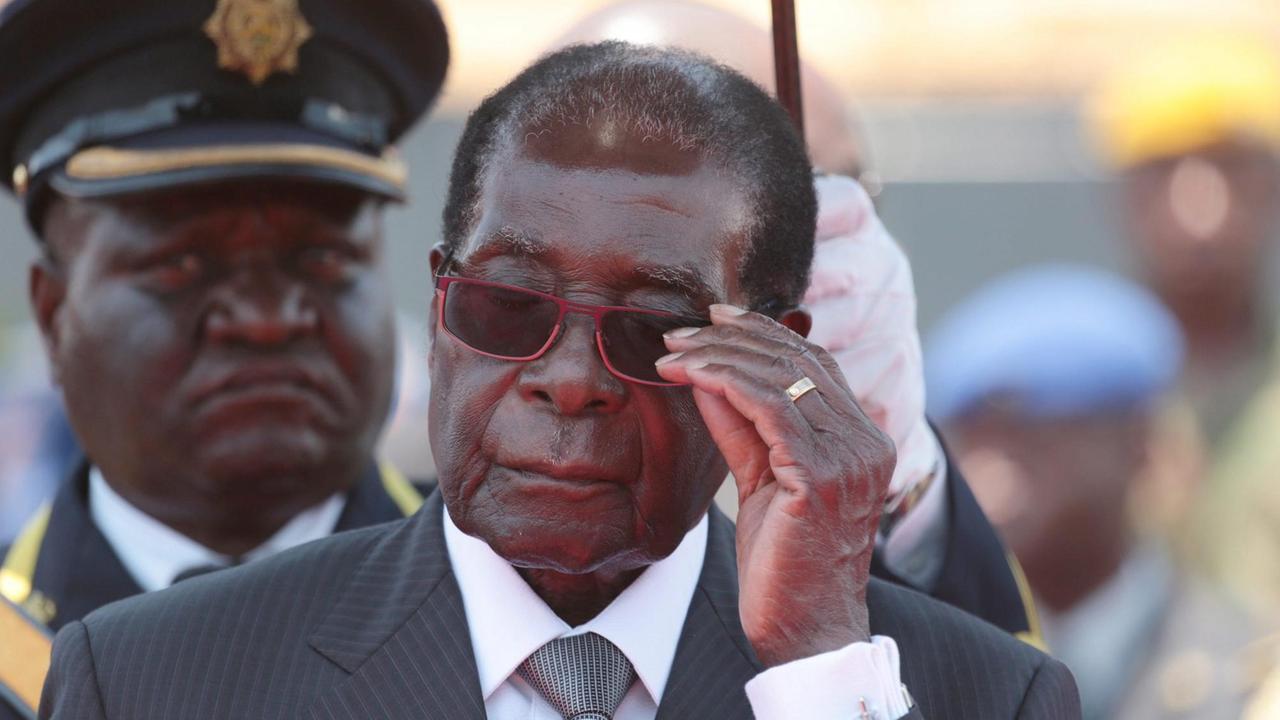 Zimbabwean President Robert Mugabe adjusts his glasses as he arrives to bid farewell and bury the late Cephas Msipa at the National Heroes Acre in Harare, Zimbabwe, 22 October 2016.